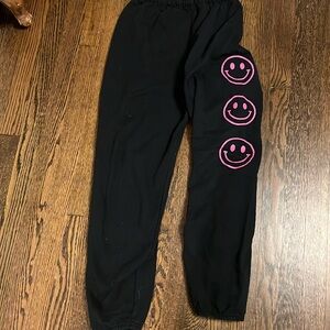 Girls black sweatpants with 3 adorable smiley faces down the left side